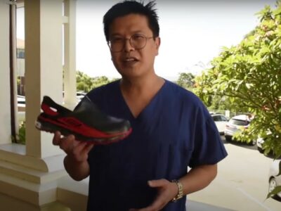 Dr Joo Teo showing his comfortable shoes for work